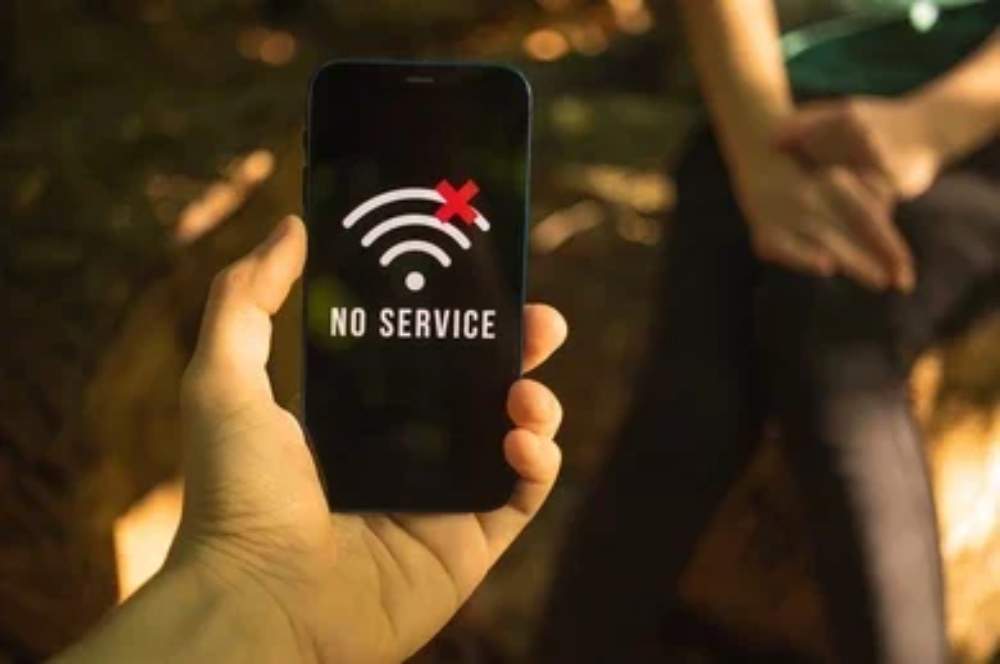A smartphone displaying "No Service" on the screen, highlighting poor mobile signal coverage indoors.